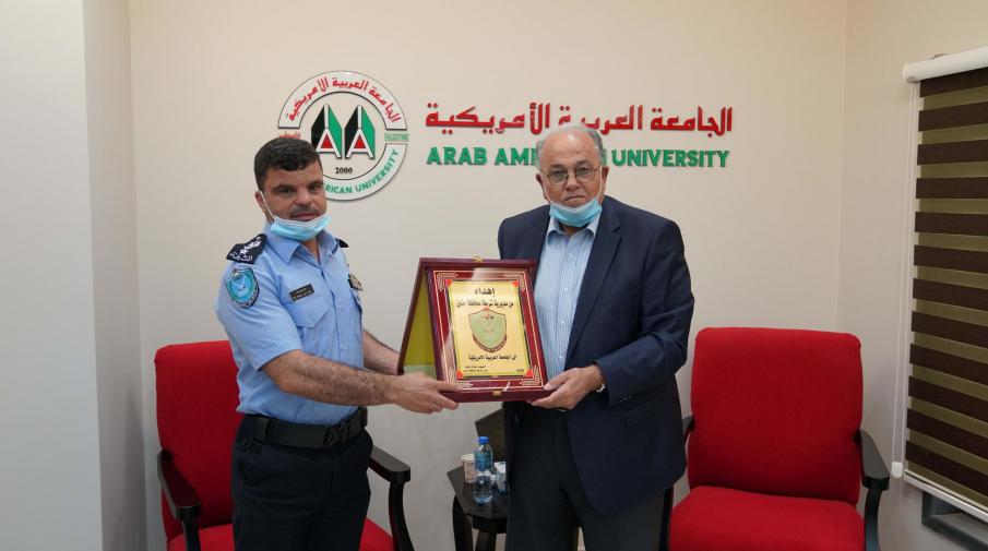 Brigadier Azzam Jbara- the Police Chief of Jenin honoring Prof. Ali Zeidan Abu Zuhri- the university President with the police shield.